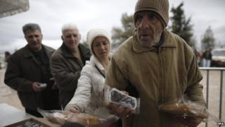 People receive food handouts in Athens on Monday