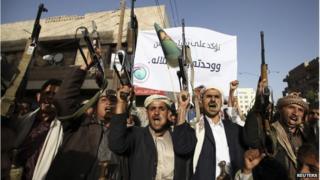 Followers of the Houthi movement shout slogans during a demonstration