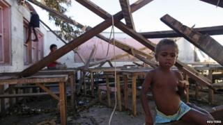 Children play in a destroyed school classroom in Tanna March 18, 2015.