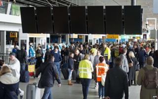 Travellers wait at Schiphol Airport, on 27 March 2015 during a major power cut