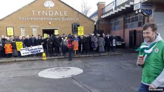 Dozens of protestors have gathered outside Tyndale Free Presbyterian Church near Windsor Park