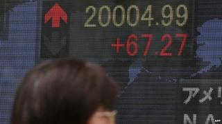 Shares board showing Nikkei above 20,000