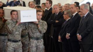 EU Commissioner on Migration Dimitris Avramopoulos (right) and Italy's Interior Minister Angelino Alfano (second right) attend an interfaith funeral ceremony of 24 migrants who died off the Libyan coast on 23 April, 2015