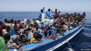 Migrants aboard a wooden boat on the Mediterranean sea