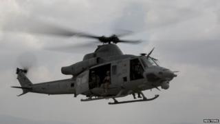 A UH-1Y Huey helicopter flies into the Tribhuvan International Airport after a search and rescue operation in Kathmandu, Nepal, May 13, 2015