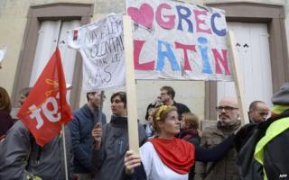 A woman holds a placard during a demonstration against proposed reforms of secondary education during a teacher's national strike day on 19 May 2015 in Strasbourg, France