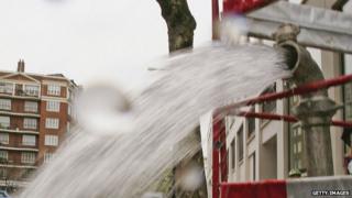 A burst pipe spews water onto a street near Lancaster Gate on May 16, 2006 in London, England.