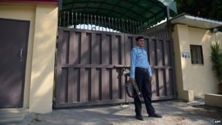 A Pakistani policeman stands guard outside the shuttered office of the international aid group Save the Children in Islamabad on June 15, 2015.