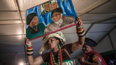 African National Congress Women League members, holding a painting, dance during the celebration of the 80th birthday of Africa National Congress stalwart Winnie Madikizela Mandela on September 26, 2016 in Soweto