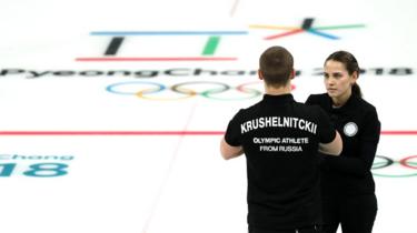 Anastasia Bryzgalova and Aleksandr Krushelnitckii of Olympic Athletes from Russia talk during their game