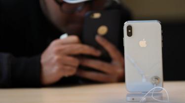 A customer takes a picture of the new iPhone X at an Apple Store on November 3, 2017 in Palo Alto, California.