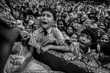 A child cries as he begs for food.