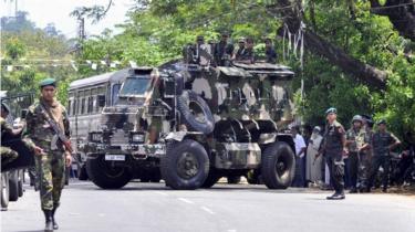 Sri Lankan police commandos patrol on the streets of Pallekele, a suburb of Kandy, on March 6, 2018, following anti-Muslim riots that has prompted the government to declare a state of emergency.