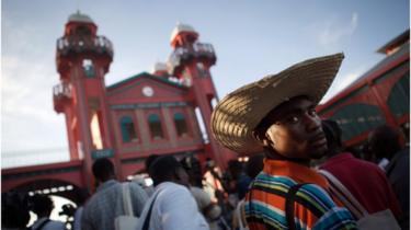 A citizen attends the reopening of the Iron Market after its destruction in the 2010 earthquake.