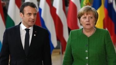 France's President Emmanuel Macron and Germany's Chancellor Angela Merkel arrive for an informal meeting of the 27 EU heads of state in Brussels, 23 February 2018