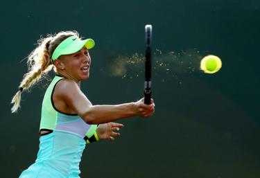 A player hits a tennis forehand shot.