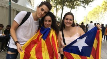 Roger Mayor (left) and his friends show off their flags