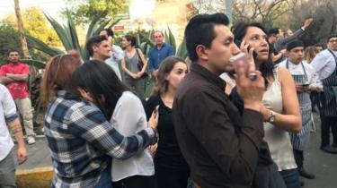 People gather on a street in Mexico City after Friday's earthquake