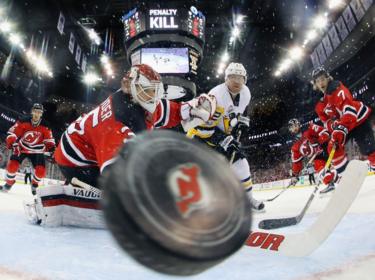 A puck flies towards the camera.