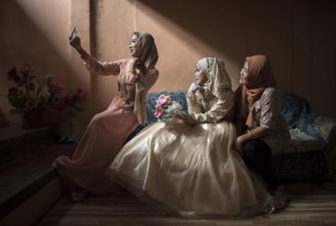 Three girls take a selfie.