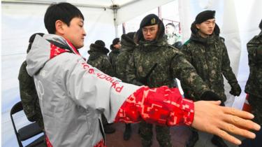 man being frisked by soldier