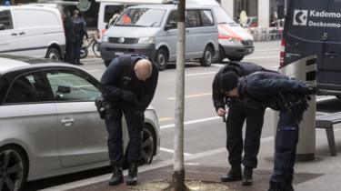 Police teams check the area following the shooting incident in Zurich