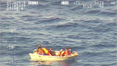 Small dinghy carrying seven people