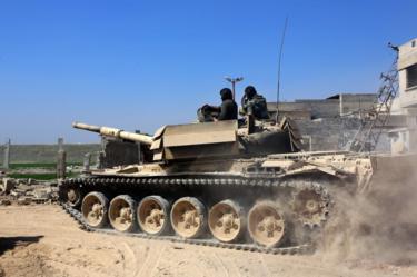 A Syrian government tank rolls towards the Eastern Ghouta near Damascus, 7 March