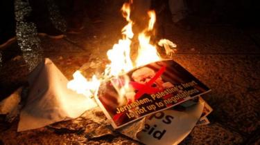 Palestinian demonstrators burn pictures with US President Donald Trump in Bethlehem, West Bank. Photo: 6 December 2017