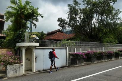 A man walks past the house of Singapore's late founding father Lee Kuan Yew at Oxley Rise in Singapore on 11 April 2016.