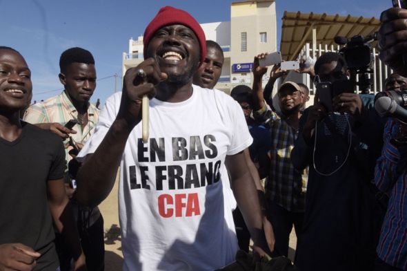 Supporters celebrate in a street of Dakar after the courthouse has decided to release activist Kemi Seba from the Rebeuss jailhouse on August 29, 2017. Kemi Seba was arrested after he burned a 5,000 CFA franc bank note during a meeting on August 19, 2017.