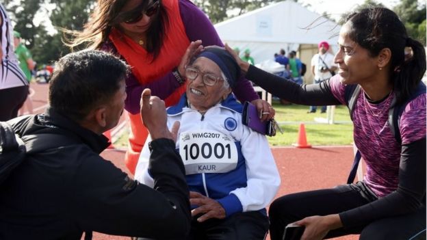 101-year-old Man Kaur of India (R) celebrates after competing in the 100m sprint in the 100+ age category at the World Masters Games at Trusts Arena in Auckland on April 24, 2017.