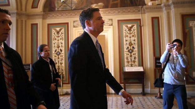 FBI Director James Comey (C) leaves a meeting with Senators at the US Capitol on March 15, 2017 in Washington