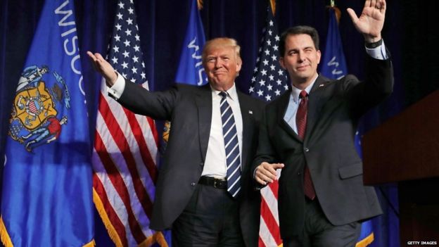 Republican presidential nominee Donald Trump (L) is welcomed to the stage by Wisconsin Governor Scott Walker