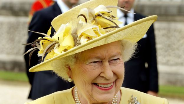 The Queen wearing a yellow floral hat