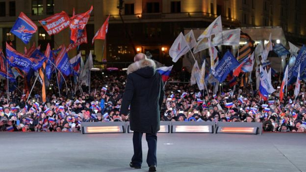 Russian President and Presidential candidate Vladimir Putin attends a rally and concert marking the fourth anniversary of Russia"s annexation of the Crimea region,