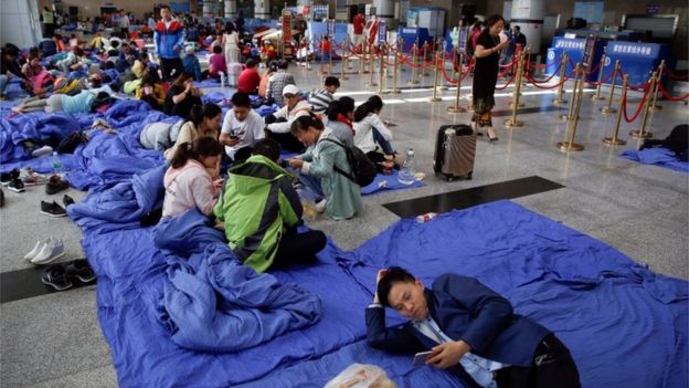 Strandedpassengers rest at the departure hall of Jiuzhaigou airport near the remote, mountainous area struck by a deadly earthquake in Sichuan province