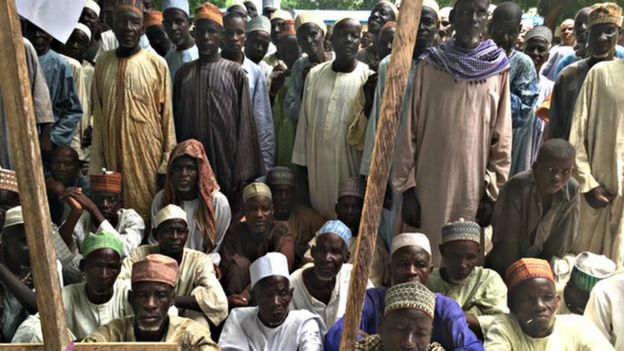 Men waiting for food at the camp in Bama, north-eastern Nigeria