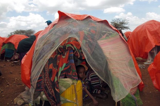 A Somali family crammed into a small tent on the outskirts of Baidoa