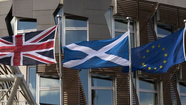 Flags of UK, Scotland and the EU in front of the Scottish Parliament in Edinburgh on June 27, 2016
