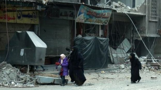 Syrian women run for cover following Syrian government bombardment on the town of Douma in the rebel-held enclave of Eastern Ghouta on the eastern outskirts of the capital Damascus on March 10, 2018.