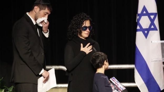 The Sherman children console each other during their memorial in Toronto, Ontario, Canada, on 21 December 2017