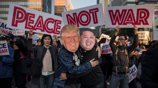 Demonstrators dressed as North Korean leader Kim Jong-Un (R) and US President Donald Trump (L) embrace during a peace rally in Seoul on November 5, 2017
