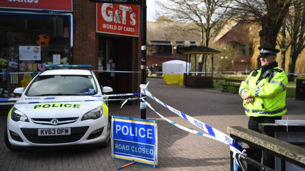 Police stand behind a cordon in Salisbury, Britain, 6 March 2018.