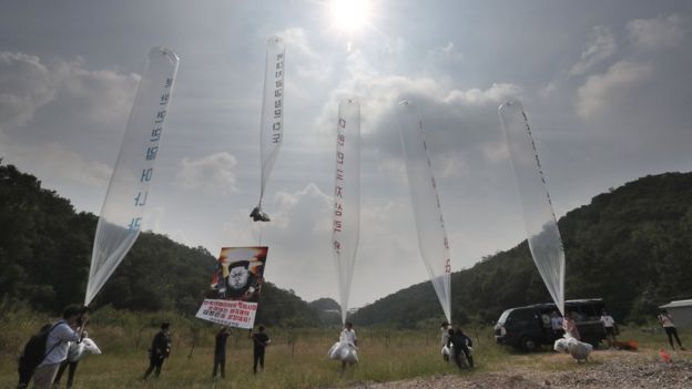 Anti-North Korea activists launch helium balloons in a field in Paju, on 15 September 2016.