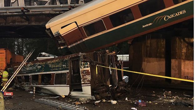 One carriage was hanging from the tracks, while another was upside down