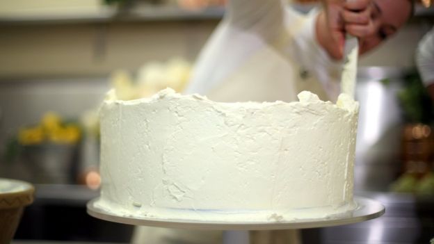 Claire Ptak puts finishes touches to the wedding cake