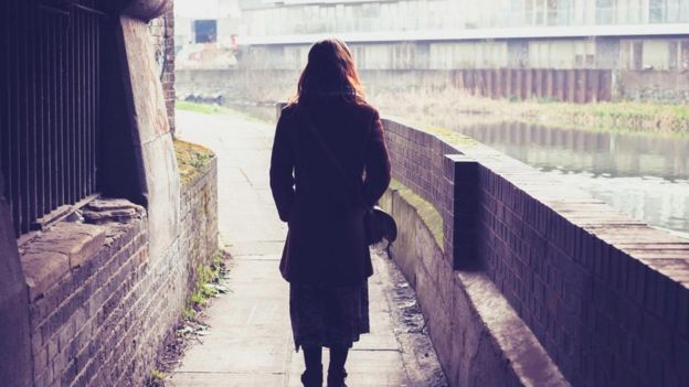 Una mujer vista de espaldas caminando