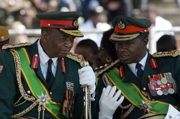 Zimbabwe's Army commander General Constantine Chiwenga (L) chats with commander of the Zimbabwe National Army, Lieutenant-General Phillip Valerio Sibanda, during the country's 28th year of independence celebration in Harare on April 18, 2008.