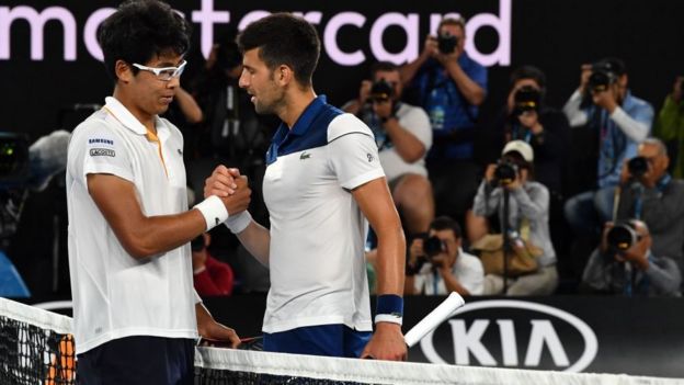 South Korea's Hyeon Chung (L) and Serbia's Novak Djokovic talk after their men's singles fourth round match